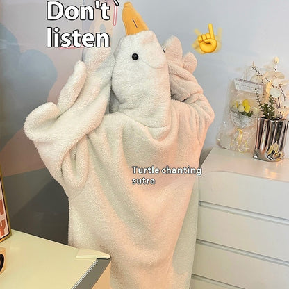 Plush toy resembling a turtle with a towel draped over it, on a desk with text and emojis.