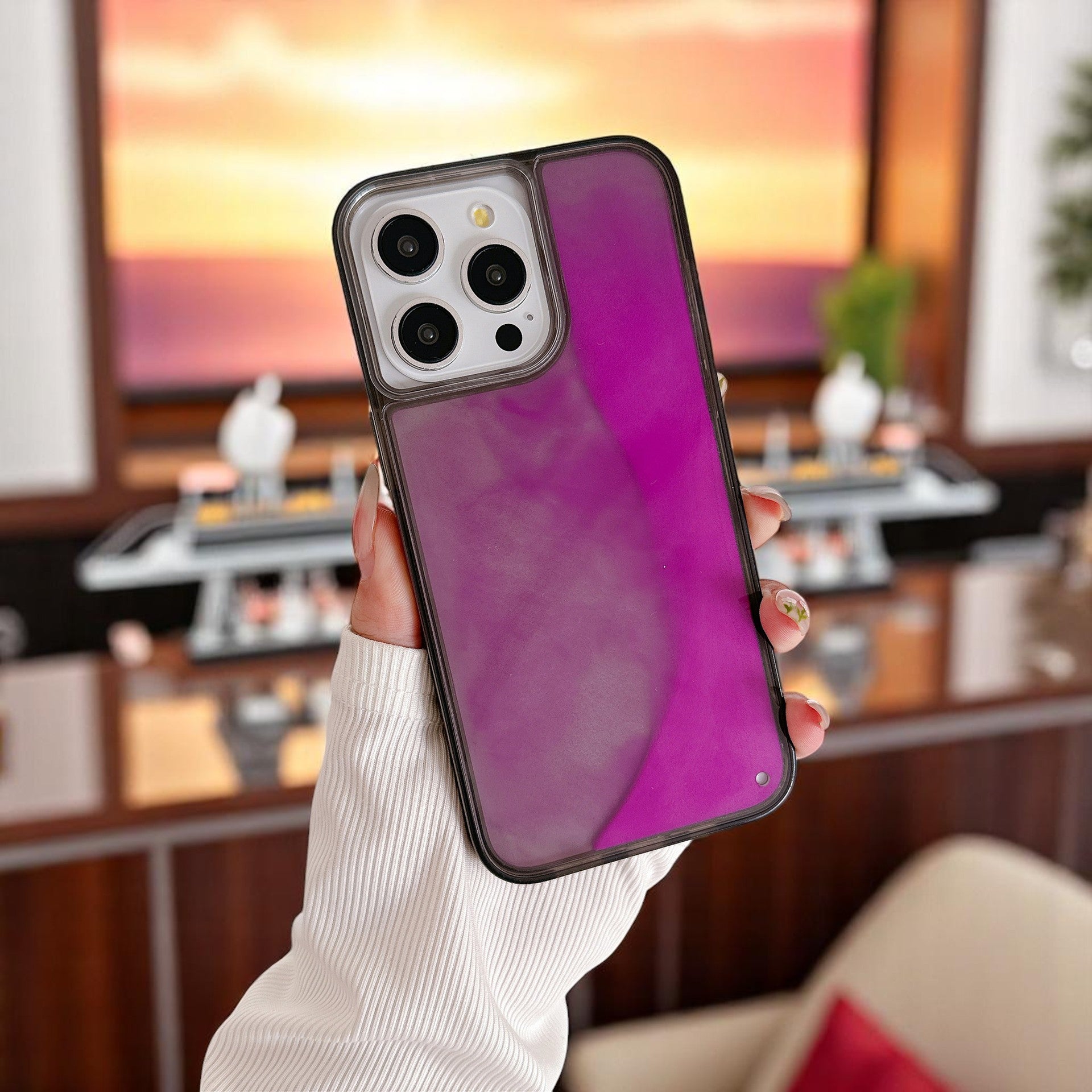 A selection of phone cases with a glowing quicksand design in various colors including red, blue, purple, and green, displayed on a white surface.