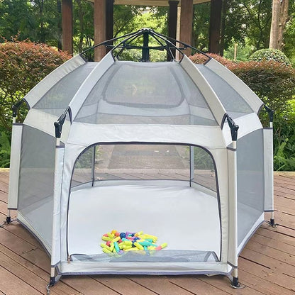 Portable playpen with mesh sides on a wooden deck