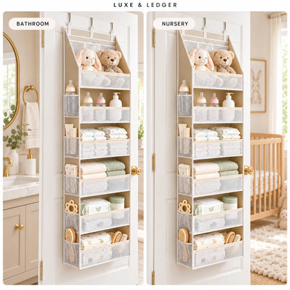 A vertical over-the-door organizer hanging on two white doors, shown in a bathroom and nursery setting. The organizer has multiple fabric compartments holding folded baby clothes, bottles, toys, and stuffed animals.