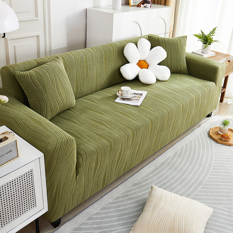 Green sofa with decorative items in a living room setting