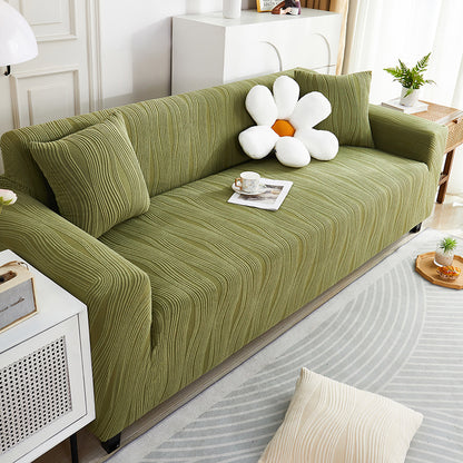 Green sofa with decorative items in a living room setting