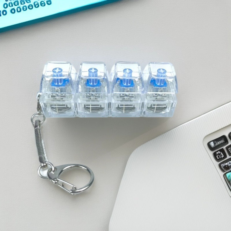 Clear plastic keychain with blue labels on a light gray surface