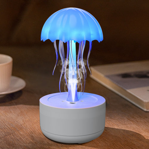 A Jellyfish Aesthetic Humidifier Diffuser with a blue light emitting mist, placed on a flat surface, with a cup and a book in the background.