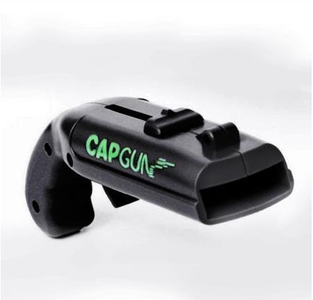 Black cap gun with green 'CAPGUN' text on a white background