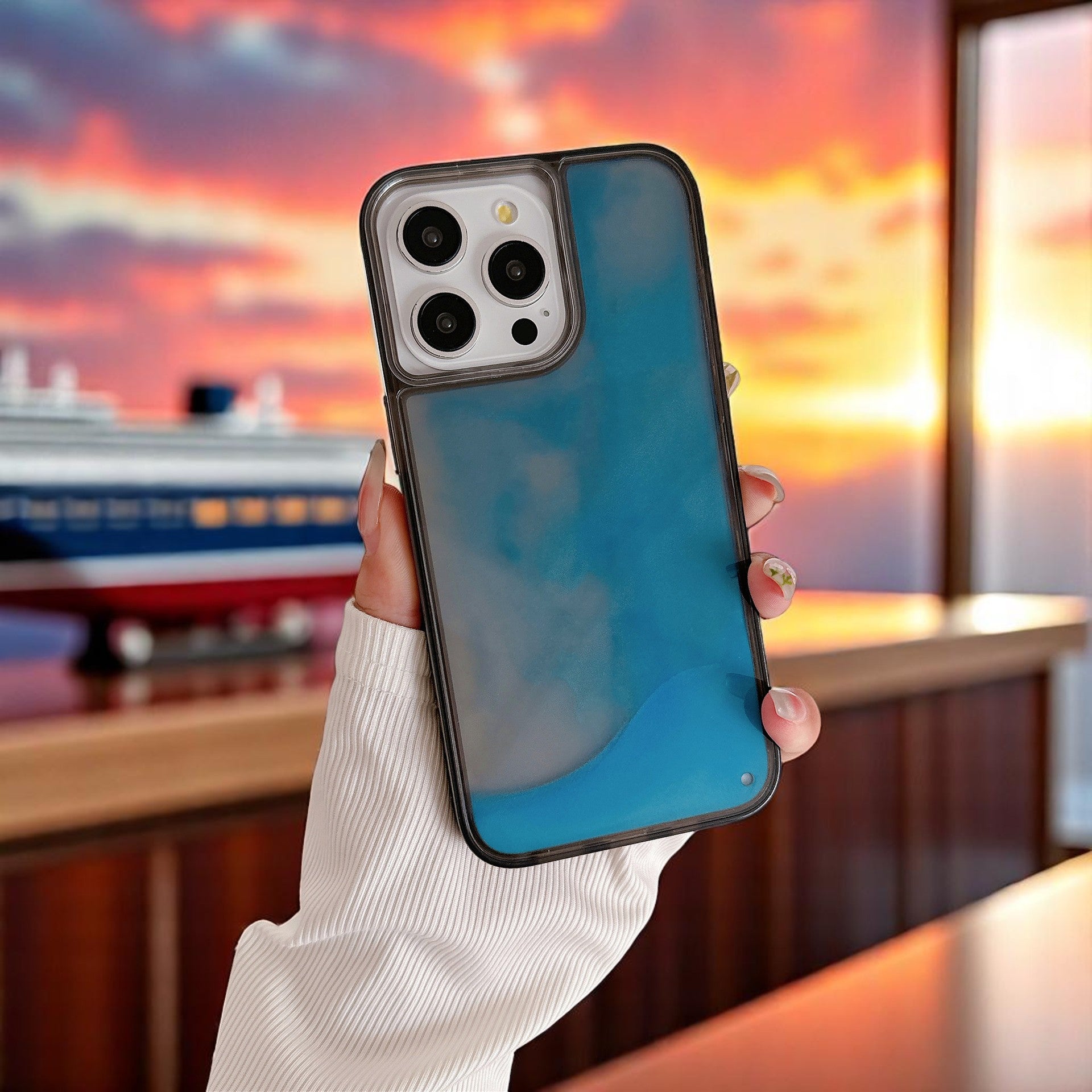 A selection of phone cases with a glowing quicksand design in various colors including red, blue, purple, and green, displayed on a white surface.