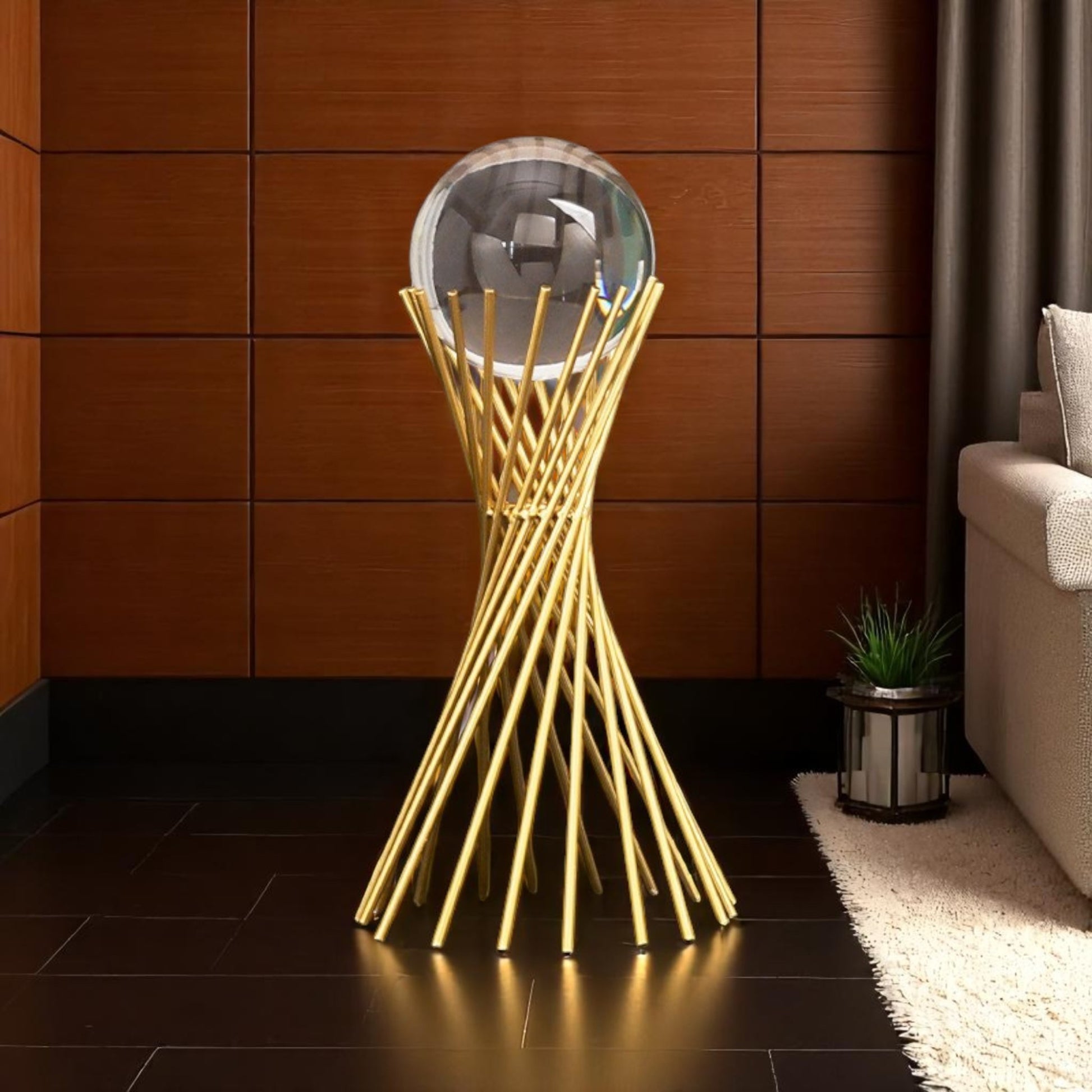 Decorative gold stand with a round mirror in a room with wooden walls and a sofa.