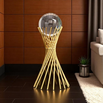 Decorative gold stand with a round mirror in a room with wooden walls and a sofa.