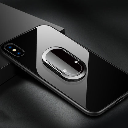 Phone case with a metallic ring holder on a dark surface