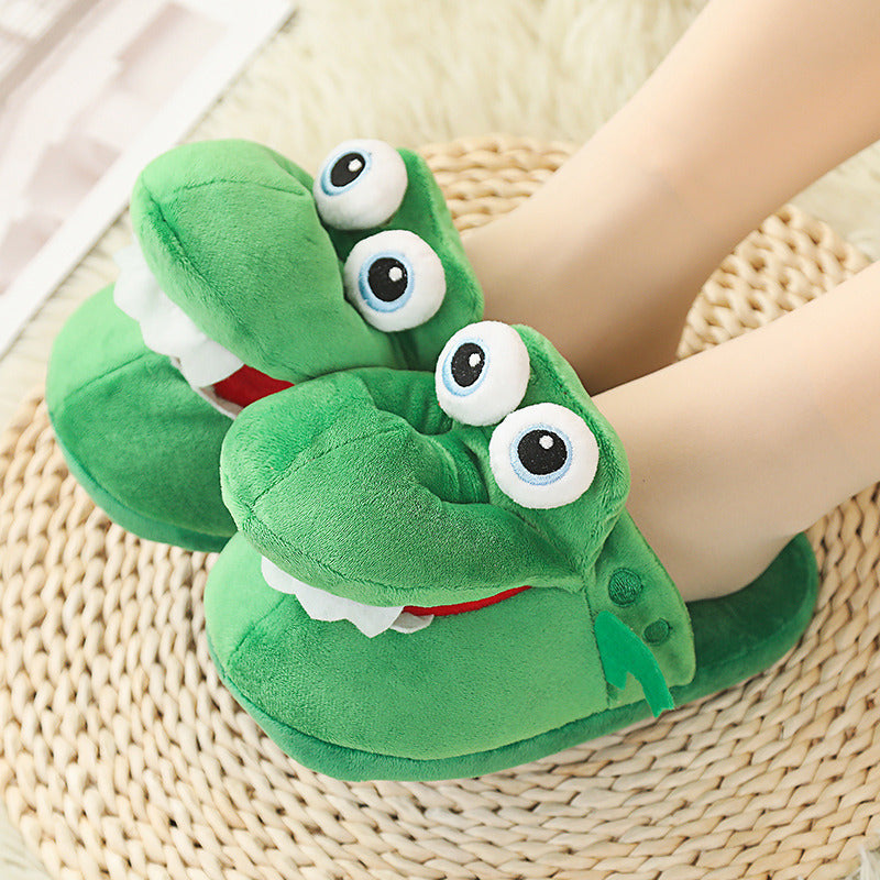 Green cartoonish slippers with large eyes on a woven mat