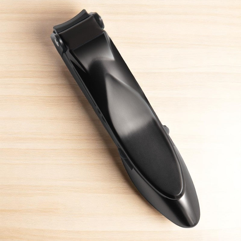 Black hair clipper on a light wooden surface