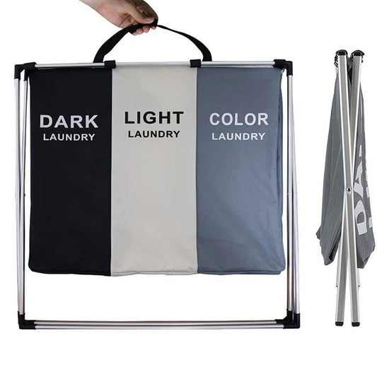 Three-section laundry sort bag labeled for dark, light, and color laundry with a hand holding it.