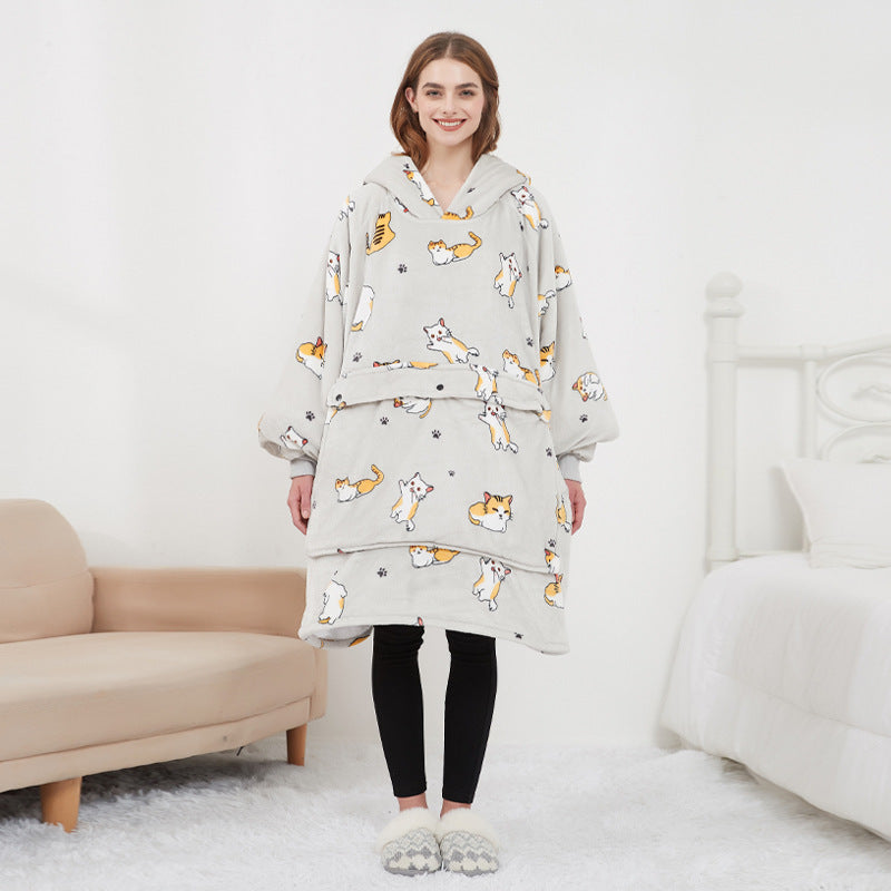 Person wearing a light gray hoodie with animal prints in a minimalistic room.