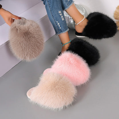 Furry slippers in various colors on a light gray surface.