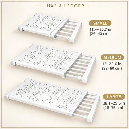 Three white expandable shower caddy slides shown in small, medium, and large sizes on a beige background, with text labels and dimensions.