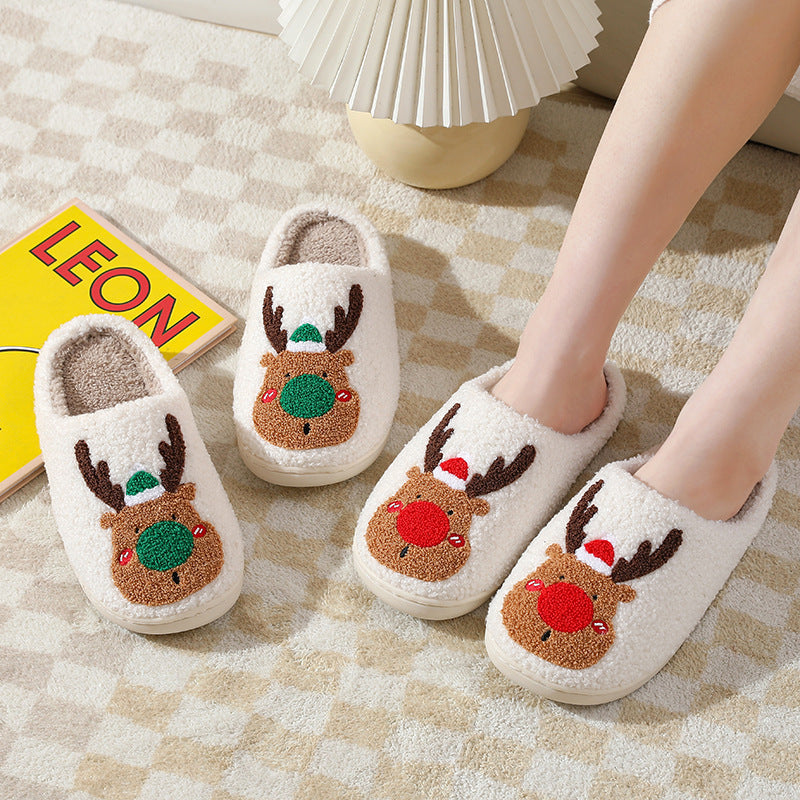 Pair of cartoon reindeer slippers on a checkered floor with a book titled 'LEON' in the background.