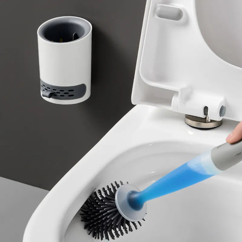 Toilet brush with holder next to a toilet, on a dark gray background