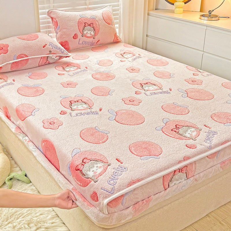 Pink cartoon-patterned bedspread on a bed in a bedroom setting