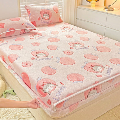 Pink cartoon-patterned bedspread on a bed in a bedroom setting