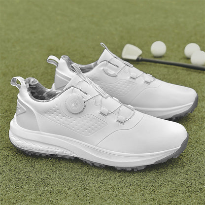 A pair of white golf shoes with a non-slip rubber sole, designed for all-terrain play on a green surface with golf balls and clubs in the background.