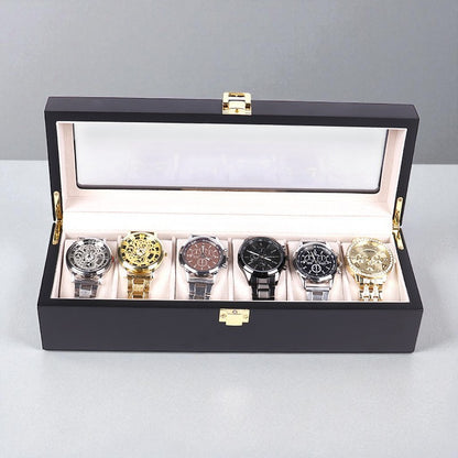Luxury black watch box with six watches displayed on a light gray background