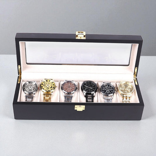 Luxury black watch box with six watches displayed on a light gray background