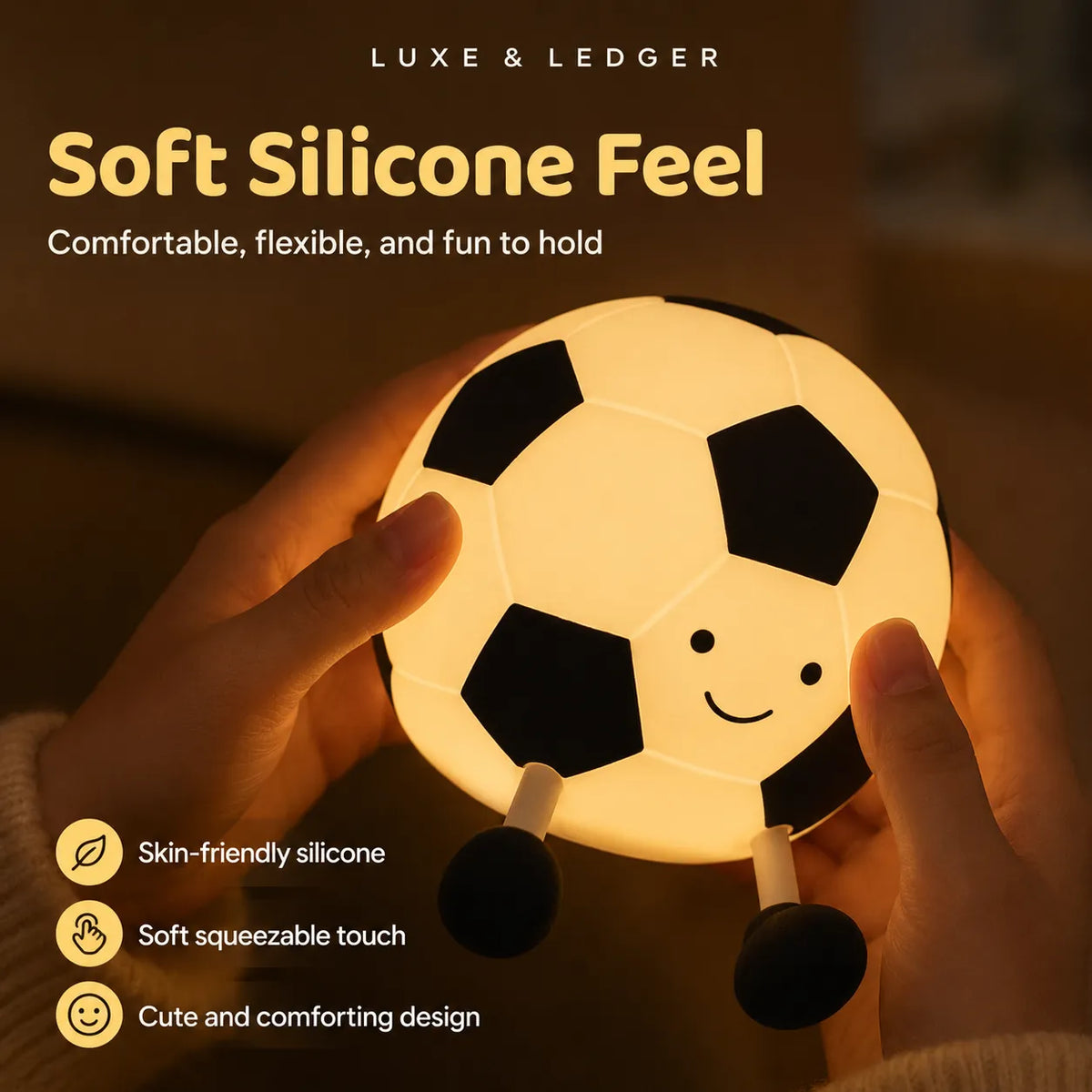 A person holds a soccer-ball-shaped night light with a warm glowing face. The image includes marketing text reading 'LUXE & LEDGER' and 'Soft Silicone Feel' with feature callouts like skin-friendly silicone, soft squeezable touch, and cute comforting design.