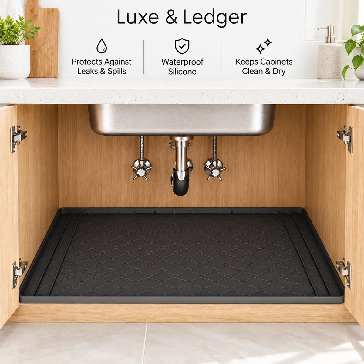 A black rubberized kitchen cabinet drain mat shown installed inside an open wooden cabinet beneath a sink. The image includes marketing text at the top reading 'Luxe & Ledger' with feature callouts: 'Protects Against Leaks & Spills,' 'Waterproof Silicone,' and 'Keeps Cabinets Clean & Dry.