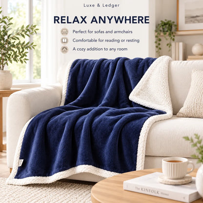 A navy blue fleece throw blanket with a cream sherpa lining draped over a white sofa in a bright living room. Text at the top reads 'Luxe & Ledger RELAX ANYWHERE' with feature bullet points.