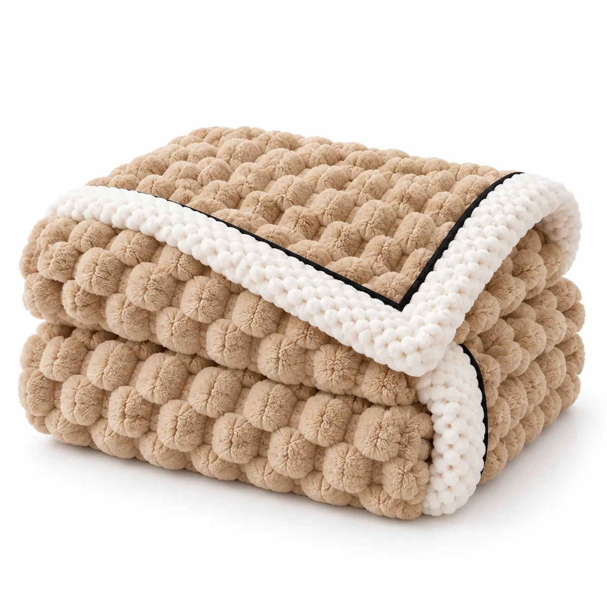 A folded chunky knit blanket with a textured beige body, a thick white border, and thin black piping, shown on a clean white background.