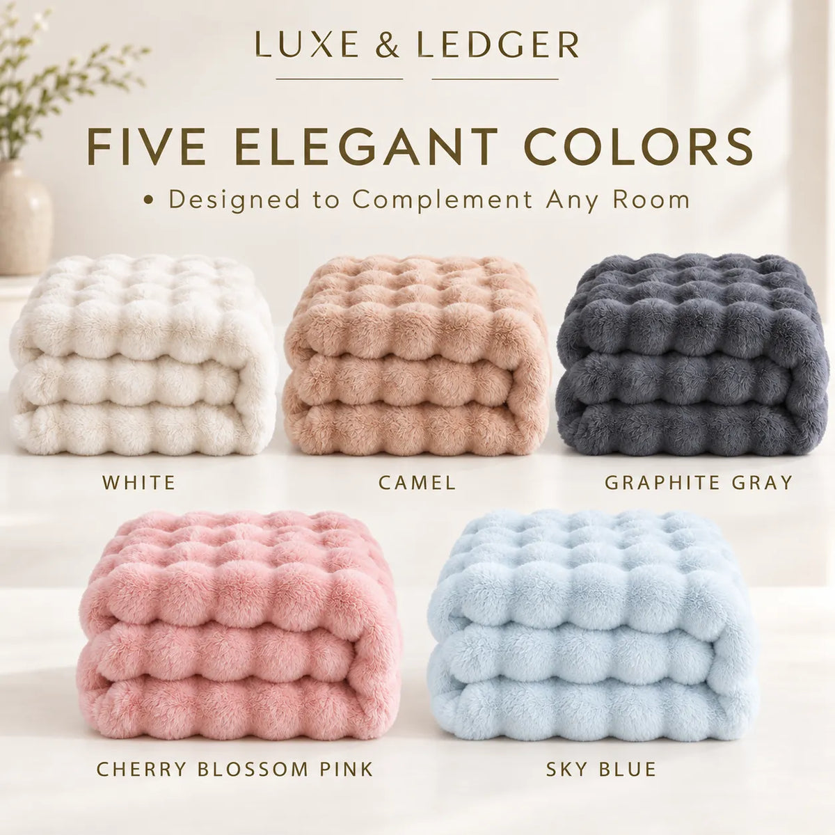 Five plush, bumpy-textured throw blankets in different colors are arranged in a grid on a light neutral surface. The top of the image includes the text 'LUXE & LEDGER' and 'FIVE ELEGANT COLORS', with color names printed below each blanket: White, Camel, Graphite Gray, Cherry Blossom Pink, and Sky Blue.
