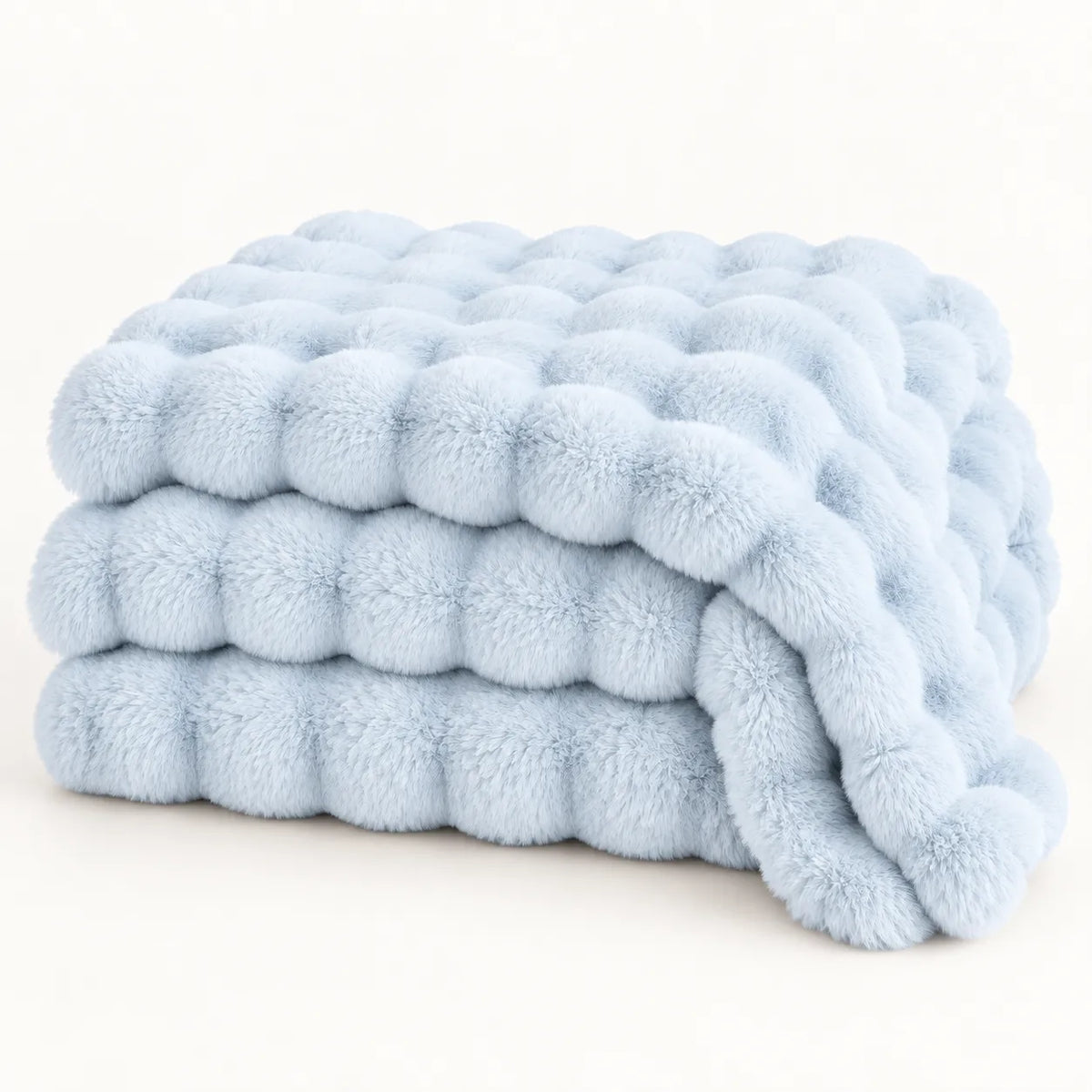 A folded light blue plush throw blanket with a textured, bumpy tufted pattern, photographed on a clean white background.