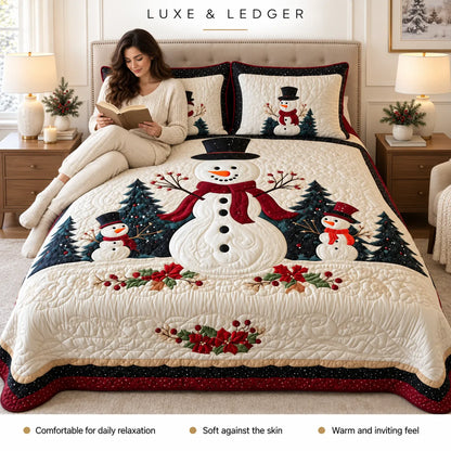 A woman sits on a bed wearing a cozy cream knit sweater and boots while reading a book. The bed is made with a large quilted winter-themed bedding set featuring embroidered snowmen, pine trees, red berries, and matching pillowcases.
