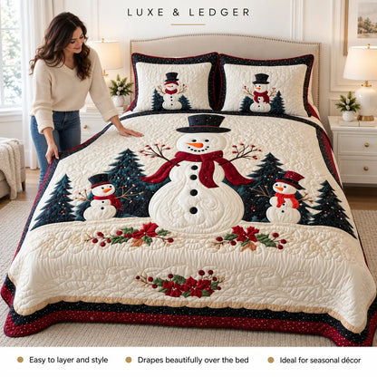 A woman is adjusting a large Christmas-themed quilted comforter on a bed in a bright bedroom. The quilt features a large snowman with a red scarf, two smaller snowmen, dark green pine trees, red berries, and a dark red border.