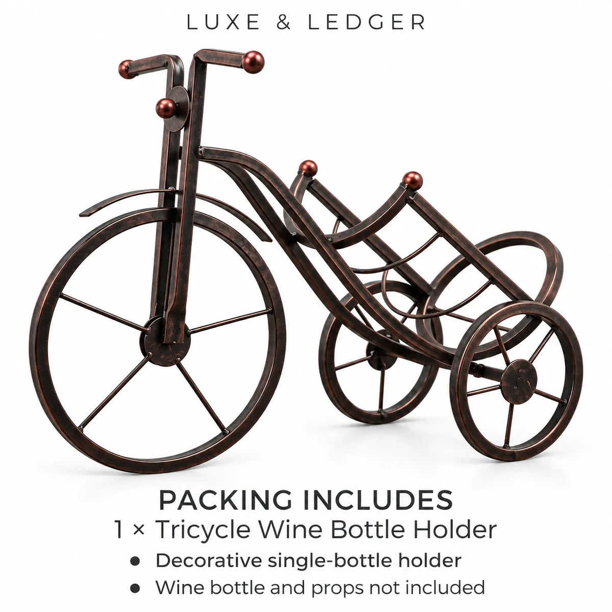 A decorative tricycle-shaped metal wine bottle holder with a dark bronze finish and small red accents on the handlebar ends, shown on a white background with Luxe & Ledger branding and packing information text.