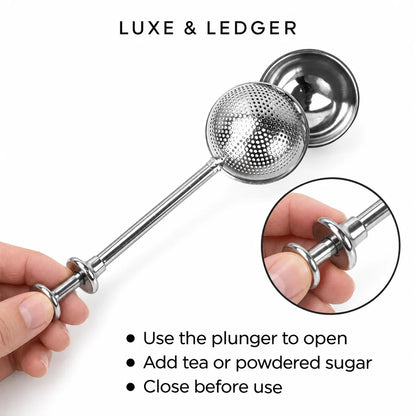 A stainless steel tea infuser plunger with a textured spherical filter head and long handle, shown being held by a hand. The image includes the text 'LUXE & LEDGER' at the top, usage bullet points at the bottom, and a circular inset close-up of the plunger mechanism.