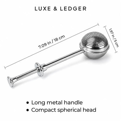 A stainless steel tea infuser with a long handle and spherical mesh head, shown on a white background with dimension lines indicating 7.09 in (18 cm) and 1.