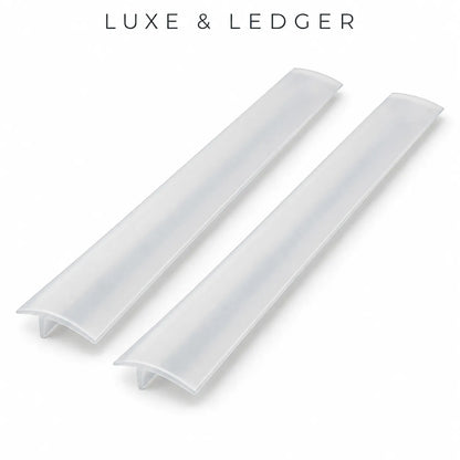 Two translucent white acrylic or PVC ledger channel profiles shown on a clean white background, with the text 'LUXE & LEDGER' printed above.