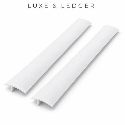Two white curved drawer pull handles shown on a clean white background with the text 'LUXE & LEDGER' at the top.