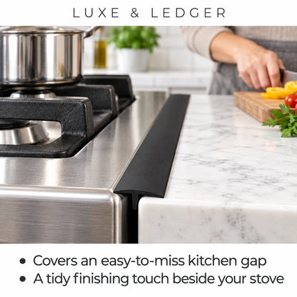A black kitchen countertop ledge trim piece shown installed beside a stainless steel gas stove in a real kitchen setting, with a person's hand visible in the background preparing food. Text at the top reads 'LUXE & LEDGER' and bullet points mention covering a kitchen gap and providing a tidy finishing touch.