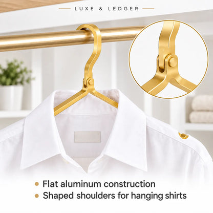 A gold-colored aluminum hanger with shaped shoulders, shown hanging a white dress shirt on a gold closet rod. The image includes a circular inset detail of the hanger's hook mechanism and text overlays reading 'LUXE & LEDGER' and 'Flat aluminum construction' and 'Shaped shoulders for hanging shirts'.