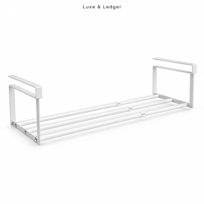 A modern white metal towel bar shelf with a minimalist design, featuring a double-bar rack and integrated side handles, shown on a clean white background with 'Luxe & Ledger' text at the top.