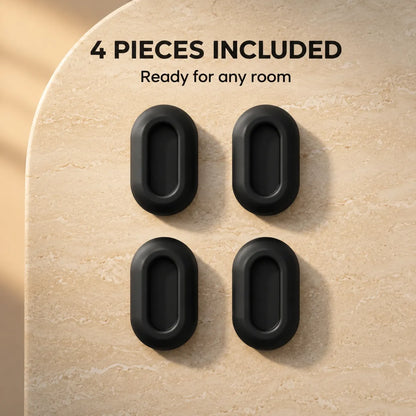 Four black oval door stoppers arranged in a 2x2 grid on a beige stone-textured surface, with the text '4 PIECES INCLUDED' and 'Ready for any room' above them.