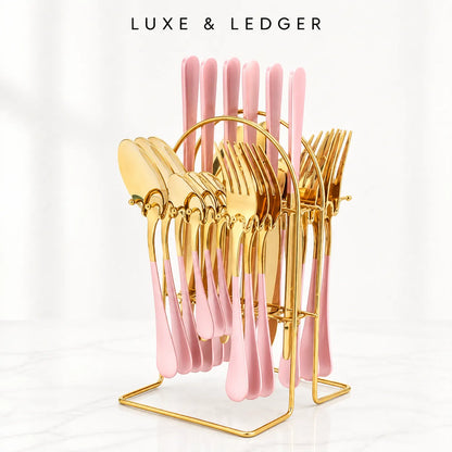 A luxury cutlery set with pink handles and gold metal heads, displayed on a gold wire stand. The set includes forks, spoons, and knives, with the brand name 'LUXE & LEDGER' printed at the top of the image.
