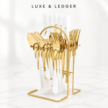 Gold metal cutlery stand holding white-handled utensils, with the brand name LUXE & LEDGER at the top on a clean white background.