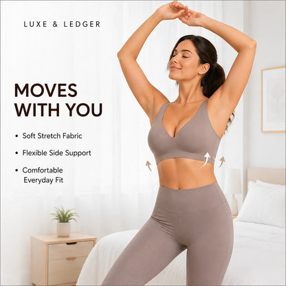 A woman in a taupe-brown sports bra and matching leggings poses in a bright bedroom setting with text overlays from Luxe & Ledger promoting stretch fabric and flexible side support.
