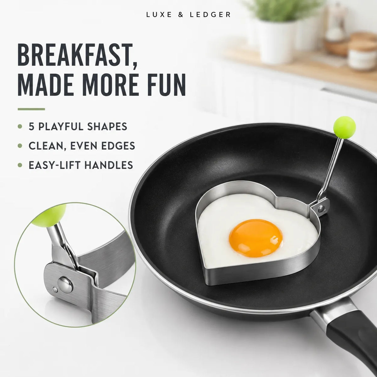 Heart-shaped egg mold in a black frying pan, cooking an egg. The image includes marketing text and a circular inset showing the metal mold's hinge detail.