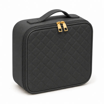 A black quilted cosmetic case with a top handle and gold-tone zipper pulls, shown on a clean white background.