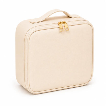 A cream-colored soft-sided rectangular case with rounded corners, a top handle, and gold-tone zipper pulls, shown on a plain white background.