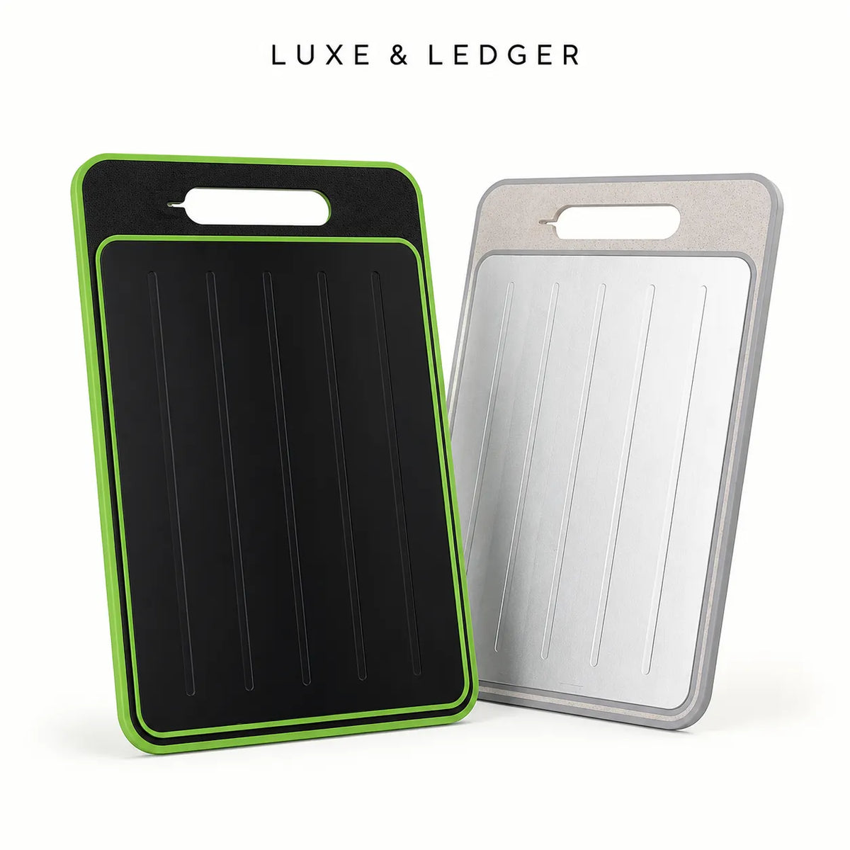 Two rectangular cutting boards with integrated handles are shown on a clean white background. The front board is black with a bright green border, and the rear board is silver with a gray border.